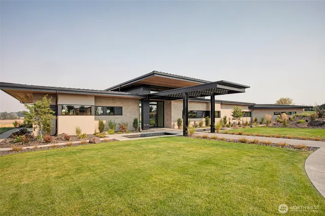 a view of a house with swimming pool and sitting area
