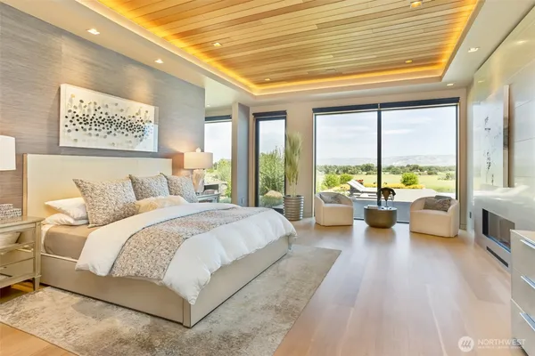 a spacious bedroom with a large bed and a large window