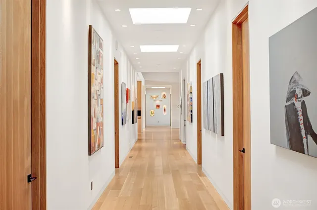 a view of a hallway with wooden floor and staircase