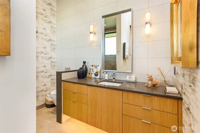 a bathroom with a granite countertop sink and a mirror