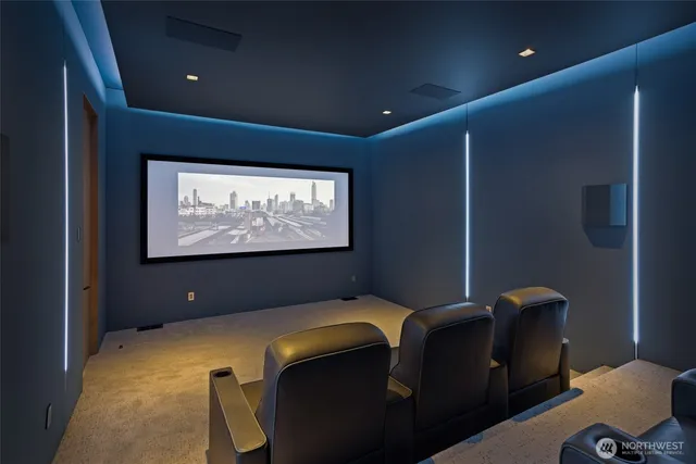 a room with furniture projector and screen