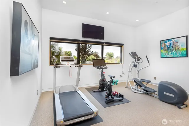 a room with gym equipment and a large window