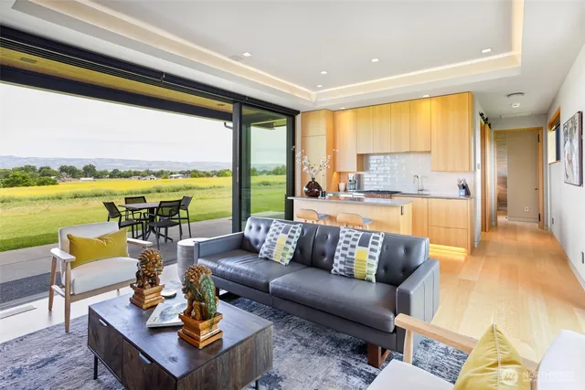 a living room with furniture and floor to ceiling windows