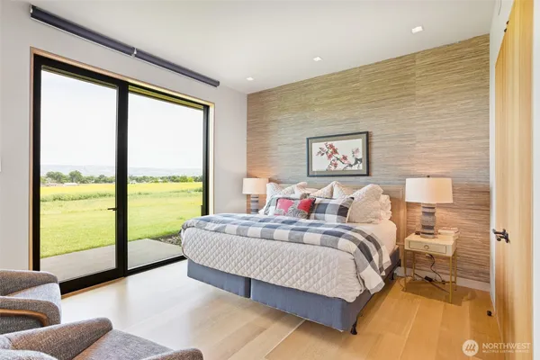 a bedroom with a large bed and a large window