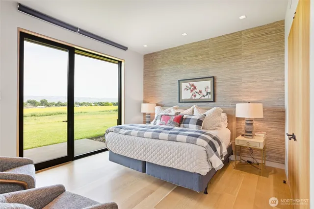 a bedroom with a large bed and a large window