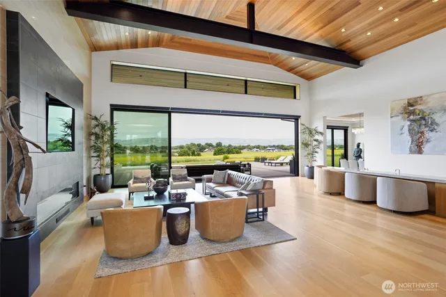 a living room with fireplace furniture and a large window