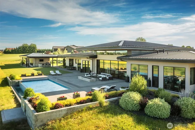 a view of swimming pool with outdoor seating and plants
