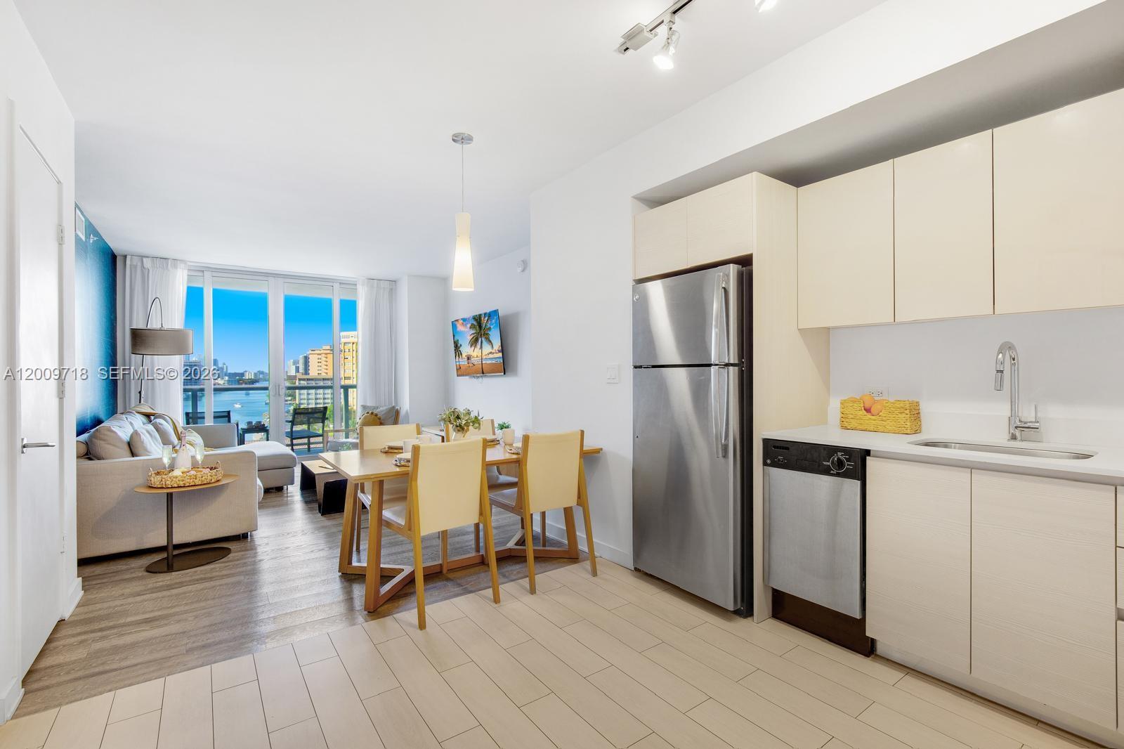 2602 East Hallandale Beach Boulevard, Unit R803 Hallandale Beach, FL 33009 - Photo 5 of 9 a living room with stainless steel appliances furniture refrigerator and a window