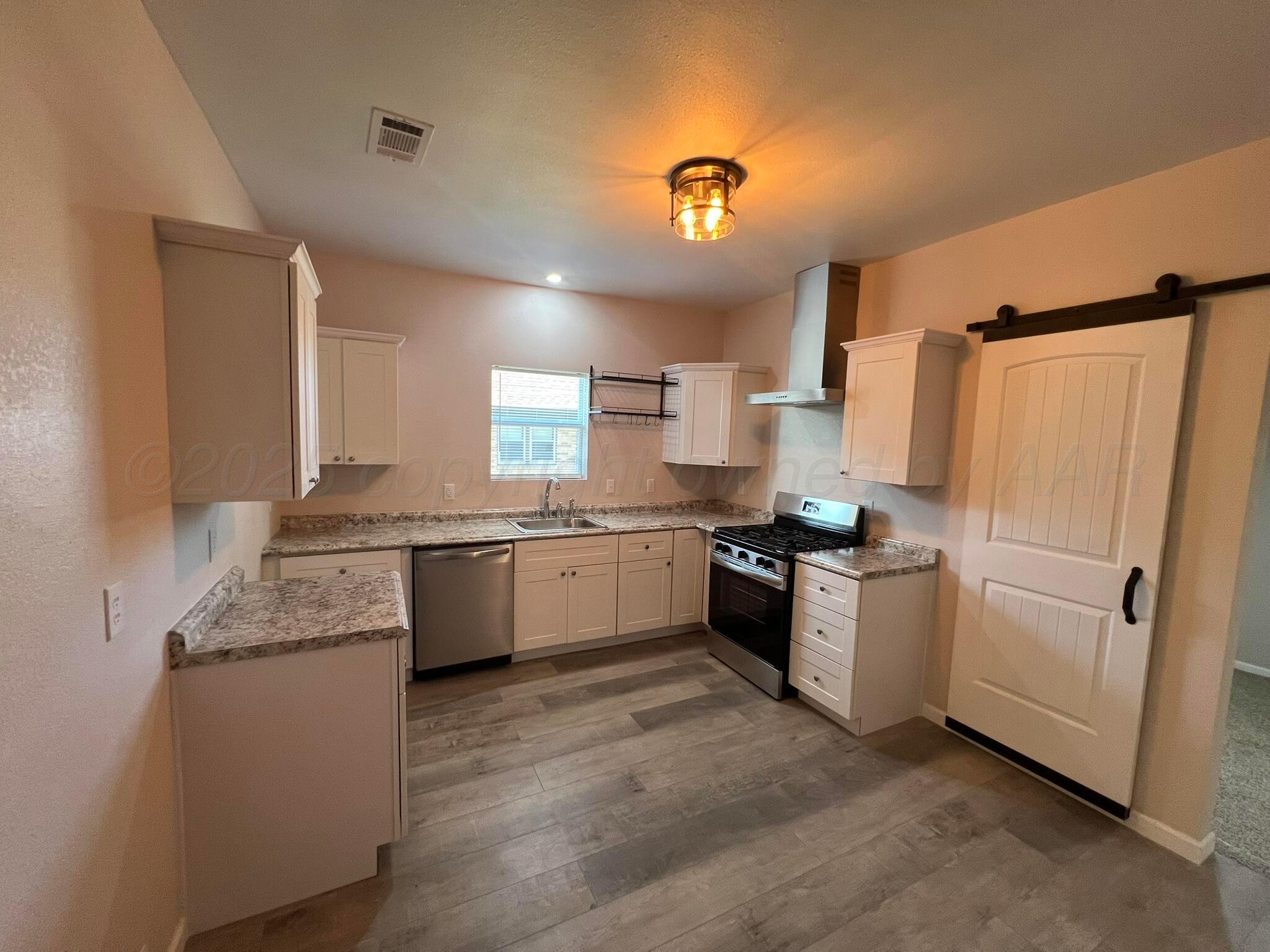 817 South 6th Street Memphis, TX 79245 - Photo 11 of 43 a kitchen with a white cabinets and white appliances