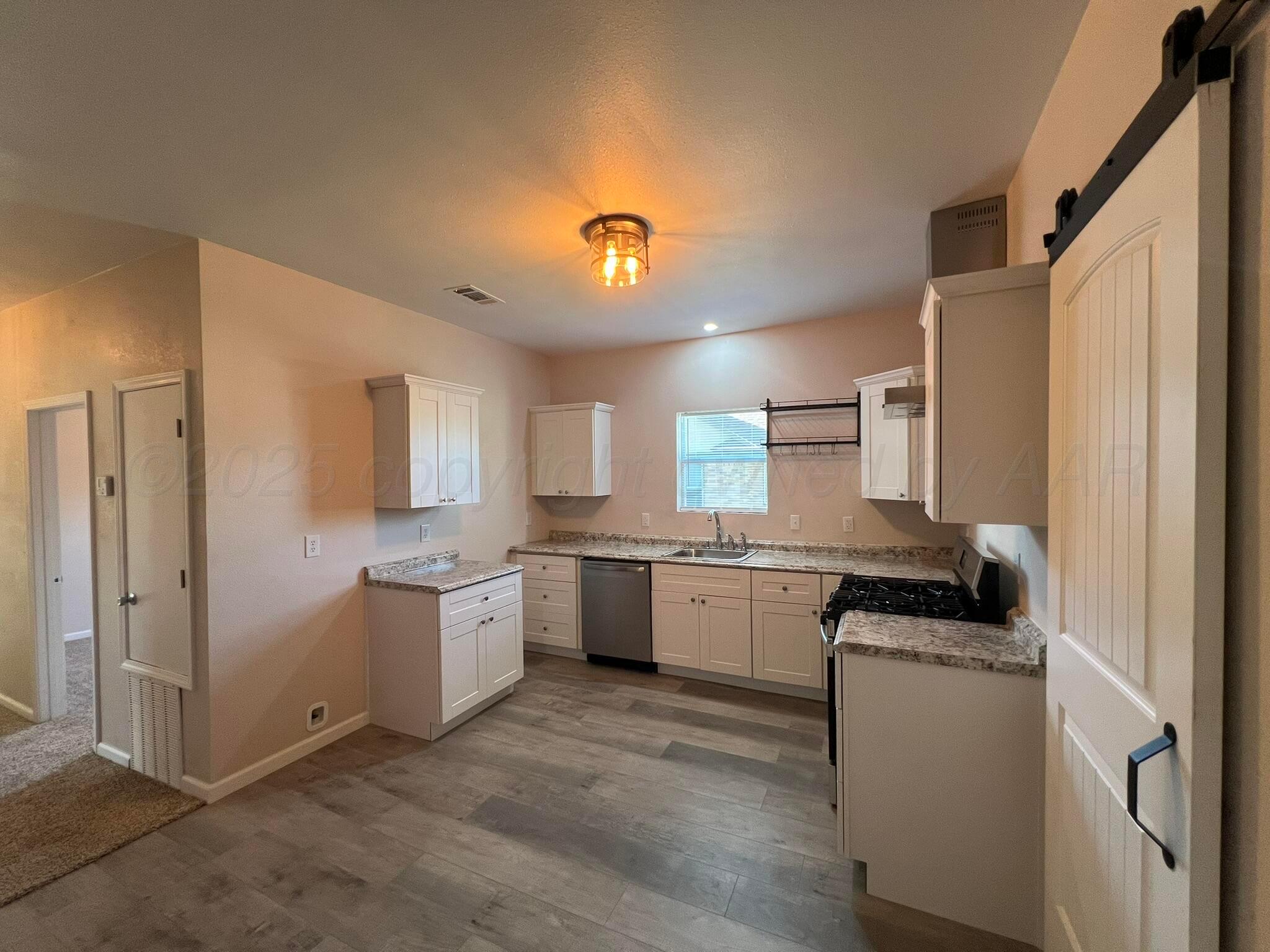 817 South 6th Street Memphis, TX 79245 - Photo 12 of 43 a kitchen with a sink stove and refrigerator