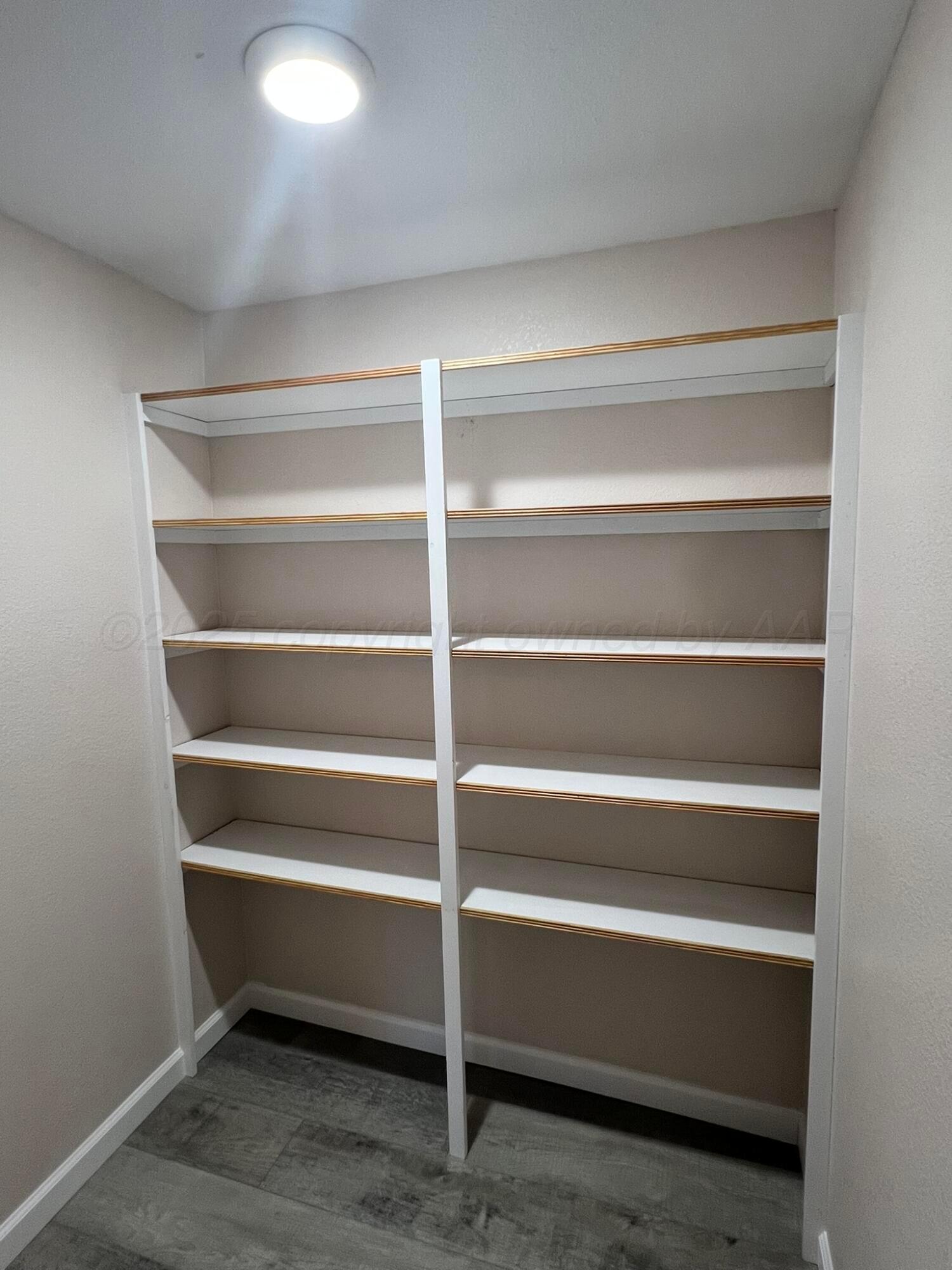 817 South 6th Street Memphis, TX 79245 - Photo 15 of 43 a view of walk in closet with empty racks