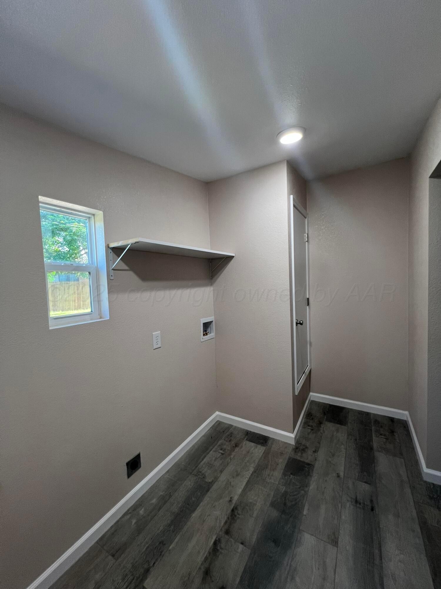 817 South 6th Street Memphis, TX 79245 - Photo 35 of 43 an empty room with wooden floor and windows