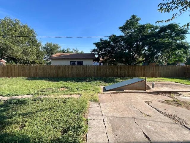 a view of a backyard with a table and chairs