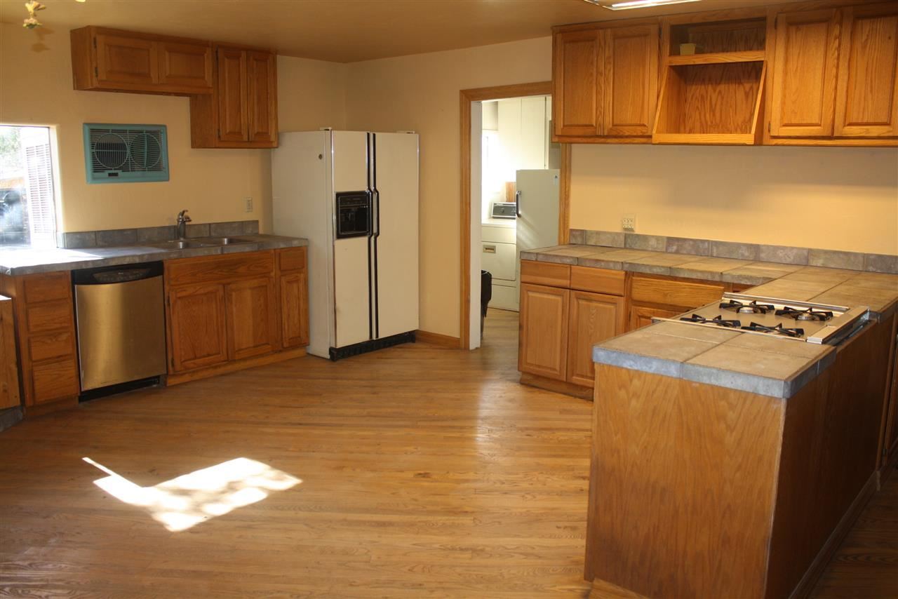 5298 Show Low Lake Road Lakeside, AZ 85929 - Photo 26 of 36 a kitchen with a stove cabinets and wooden floor