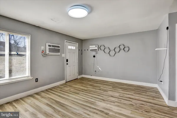 a view of a room with wooden floor and window