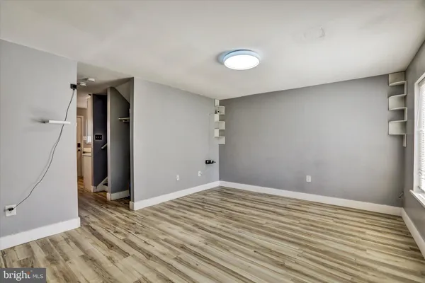 a view of a room with wooden floor and white walls