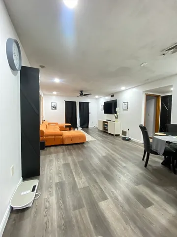 a bedroom with furniture and a large window