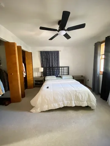 a bed sitting in a room next to a window