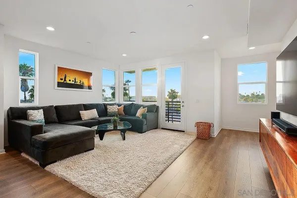 a living room with furniture wooden floor and a flat screen tv