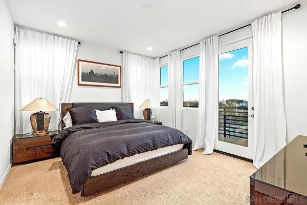 a bedroom with a large bed and a window