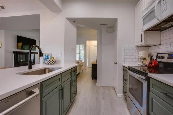 a kitchen with a sink and cabinets