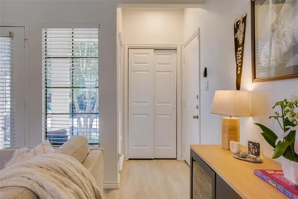 a bedroom with a bed and a lamp on the dresser