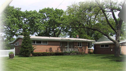 6312 Park Ridge Road Loves Park, IL 61111 - Photo 1 of 1 a front view of a house with a garden