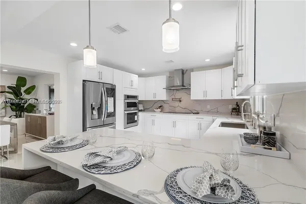 a large kitchen with a table and chairs