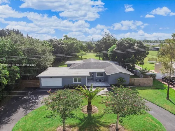 a aerial view of a house with a garden and lake view