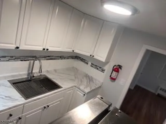 a kitchen with a sink and a stove top oven