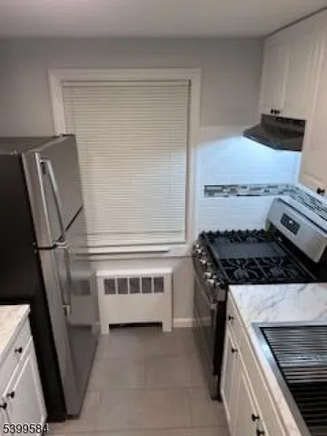 a kitchen with a stove and a refrigerator