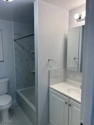 a bathroom with a granite countertop sink a toilet and shower
