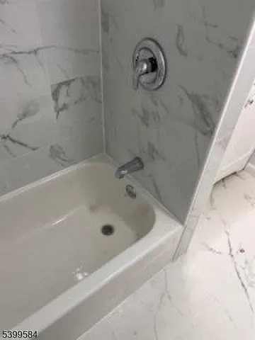 a bathroom with a tub and a shower