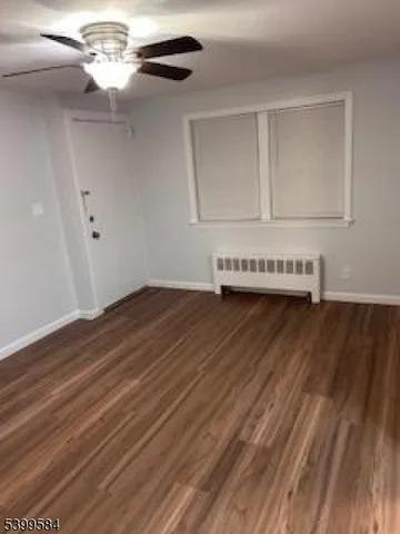 a view of a room with wooden floor