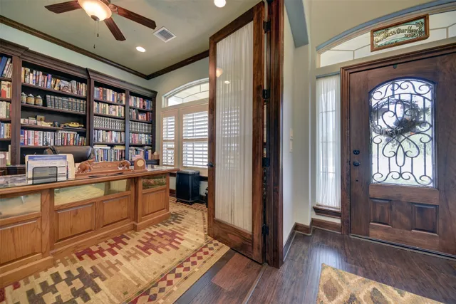 a bedroom with a bed a flat screen tv and a fireplace