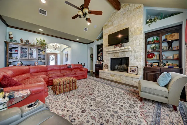 a kitchen with stainless steel appliances granite countertop a stove refrigerator dining table and chairs with wooden floor