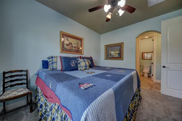 a room with furniture a flat screen tv and a chandelier