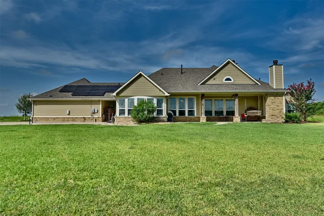 an aerial view of a house with yard