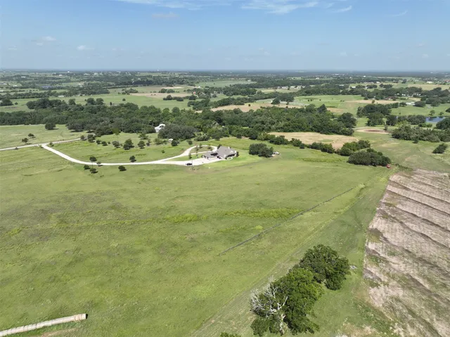 a front view of a house with yard and green space