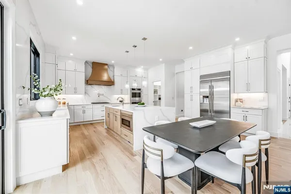 a kitchen with stainless steel appliances a stove a sink dishwasher and a refrigerator