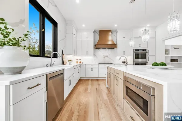 a view of a kitchen with wooden floor and cabinets