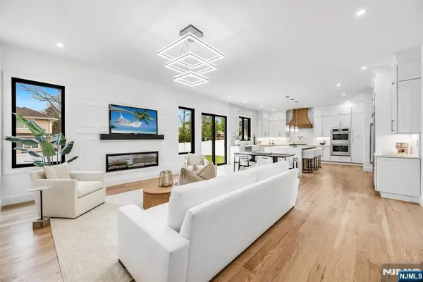 a living room with furniture and kitchen view