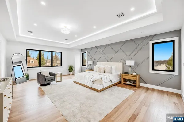 a bedroom with a large bed and a flat screen tv