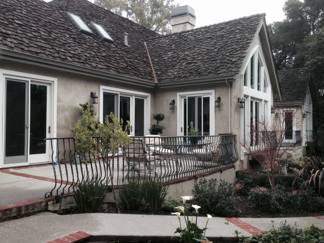 a front view of house with a garden