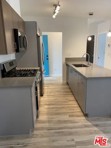 a kitchen with granite countertop a stove and a sink