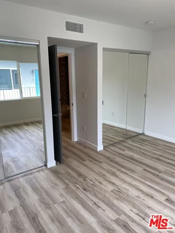 a view of a room with wooden floor