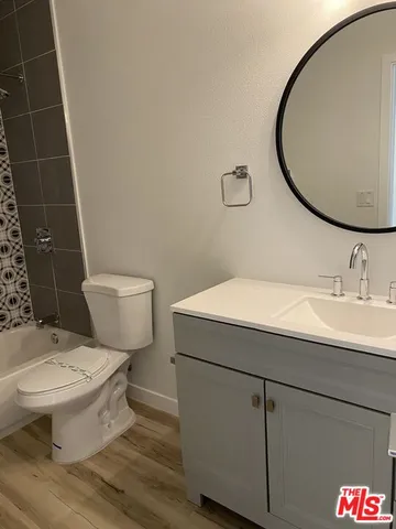 a bathroom with a sink toilet and a mirror