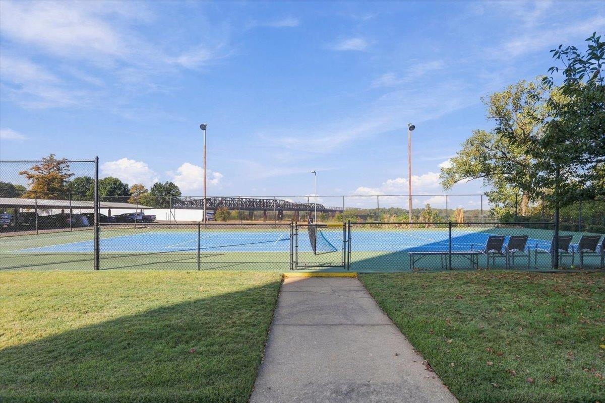 655 Riverside Drive, Unit 608B Memphis, TN 38103 - Photo 28 of 28 Tennis court with a blue and green playing surface, surrounded by a chain-link fence