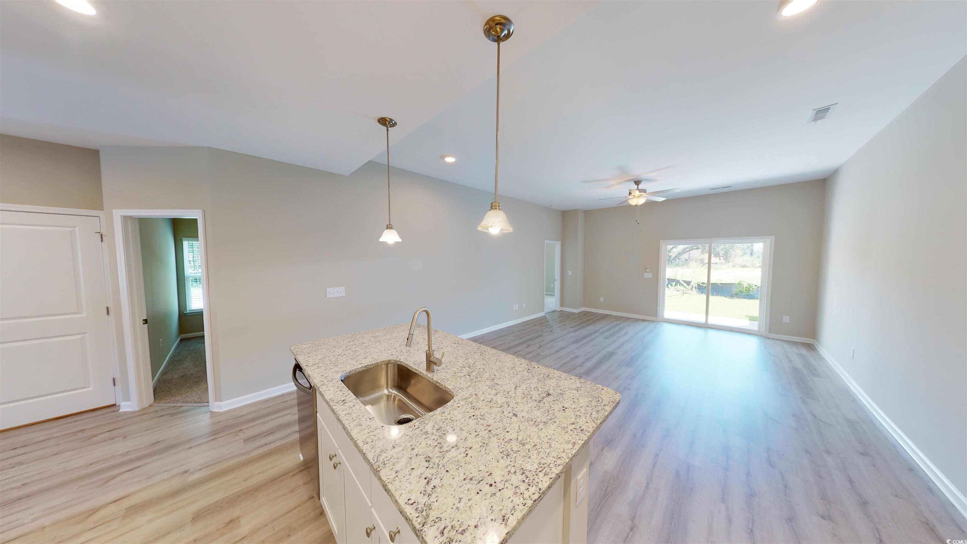 84 Racquet Club Drive, Unit WVC 14 Pawleys Island, SC 29585 - Photo 9 of 26 Kitchen with white cabinets, light wood-type flooring, recessed lighting, pendant lighting, and light stone countertops