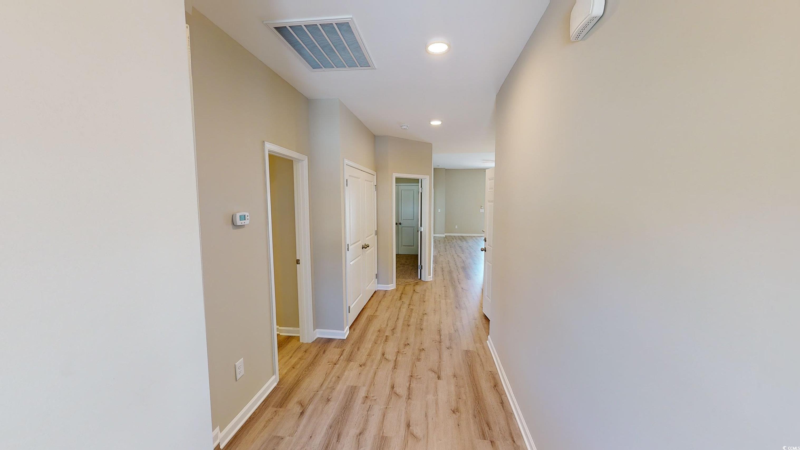 84 Racquet Club Drive, Unit WVC 14 Pawleys Island, SC 29585 - Photo 2 of 26 Hallway featuring light wood-style floors and recessed lighting